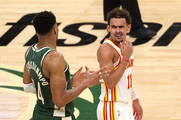 MILWAUKEE, WISCONSIN - JUNE 23: Trae Young #11 of the Atlanta Hawks reacts to a foul by Giannis Antetokounmpo #34 of the Milwaukee Bucks during the fourth quarter in game one of the Eastern Conference Finals at Fiserv Forum on June 23, 2021 in Milwaukee, Wisconsin. (Photo by Stacy Revere/Getty Images)