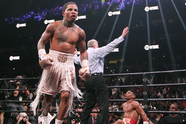 CORRECTS SURNAME OF REFEREE TO REISS, INSTEAD OF WEISS - Gervonta Davis, left, heads to the corner as Yuriorkis Gamboa, right, looks up at referee Jack Reiss during the WBA secondary lightweight title boxing bout early Sunday, Dec. 29, 2019, in Atlanta. Davis won when the fight was stopped in the 12th round. (AP Photo/Tami Chappell)