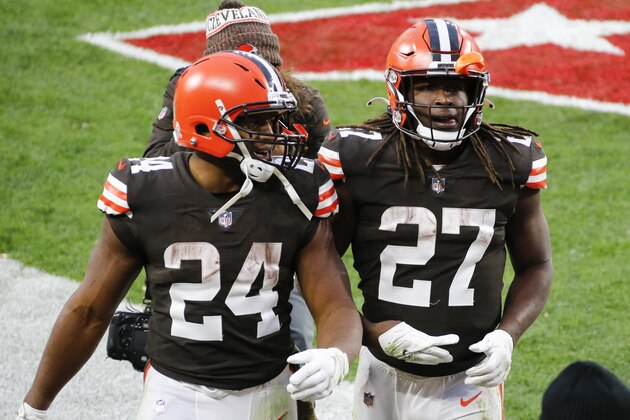 File-This Nov. 15, 2020, file photo shows Cleveland Browns running backs Nick Chubb (24) and Kareem Hunt (27) walking off the field after the Browns defeated the Houston Texans in Cleveland. One is quiet, super steady, and a rising NFL star. Cleveland's other running back is outgoing, flashy, and has his career back on track after a major detour. Chubb and Hunt couldn't be any different. (AP Photo/Ron Schwane, File)
