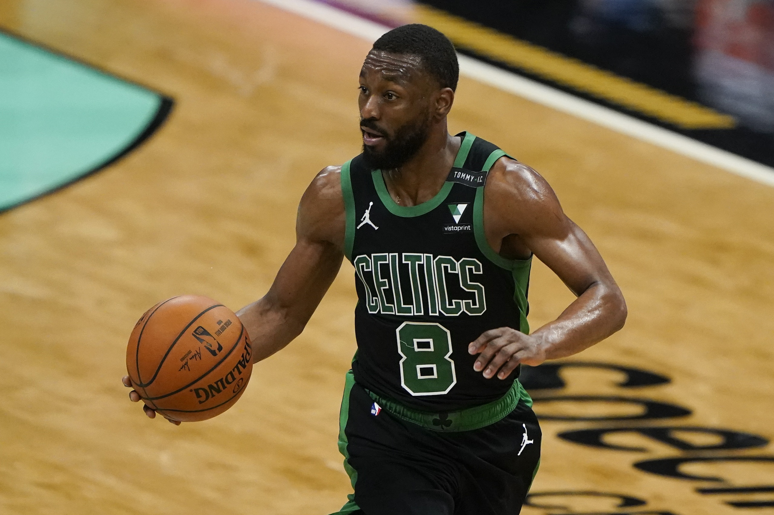 Boston Celtics guard Kemba Walker brings the ball down court against the Charlotte Hornets during the second half of an NBA basketball game on Sunday, April 25, 2021, in Charlotte, N.C. (AP Photo/Chris Carlson)