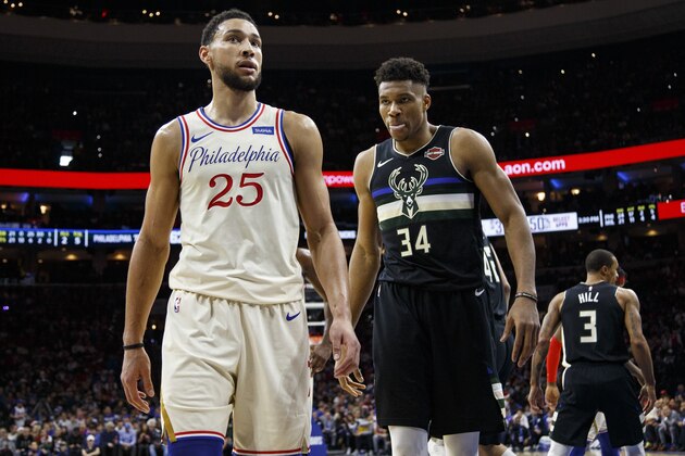 Philadelphia 76ers' Ben Simmons, left, looks on with Milwaukee Bucks' Giannis Antetokounmpo, right, during the first half of an NBA basketball game, Wednesday, Dec. 25, 2019, in Philadelphia. The 76ers won 121-109. (AP Photo/Chris Szagola)