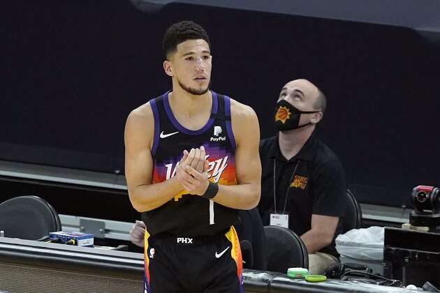 Phoenix Suns guard Devin Booker prepares to enter the game during the second half of Game 2 of the NBA basketball Western Conference Finals against the Los Angeles Clippers, Tuesday, June 22, 2021, in Phoenix. (AP Photo/Matt York)