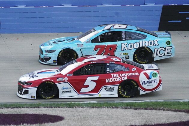 Winning driver Kyle Larson (5) passes BJ McLeod (78) in the final laps at Nashville Superspeedway during a NASCAR Cup Series auto race Sunday, June 20, 2021, in Lebanon, Tenn. (AP Photo/Mark Humphrey)