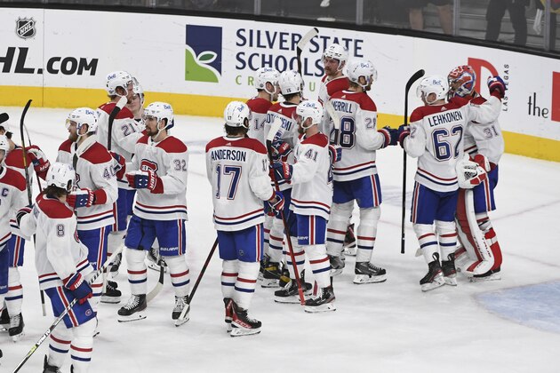 Montreal Canadiens goaltender Carey Price, far right, is greeted by teammates after the Canadiens defeated the Vegas Golden Knights 3-2 in Game 2 of an NHL hockey Stanley Cup semifinal playoff series, Wednesday, June 16, 2021, in Las Vegas. (AP Photo/David Becker)