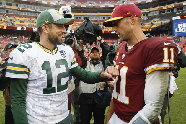 Green Bay Packers quarterback Aaron Rodgers (12) talks with Washington Redskins quarterback Alex Smith (11) after an NFL football game, Sunday, Sept. 23, 2018 in Landover, Md. The Redskins defeated the Packers 31-17. (AP Photo/Alex Brandon)