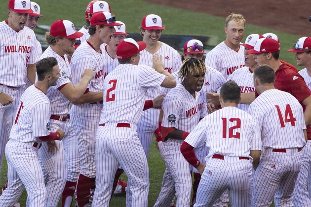 North Carolina State's Terrell Tatum, right center, celebrates with teammates after hitting a solo home run in the fifth inning against Vanderbilt during a baseball game in the College World Series, Monday, June 21, 2021, at TD Ameritrade Park in Omaha, Neb. (AP Photo/Rebecca S. Gratz)