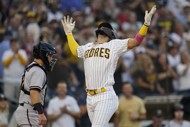 San Diego Padres' Fernando Tatis Jr., right, reacts after hitting a home run during the first inning of a baseball game as Arizona Diamondbacks catcher Daulton Varsho looks on Friday, June 25, 2021, in San Diego. (AP Photo/Gregory Bull)