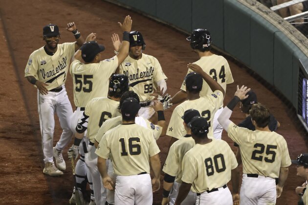 Vanderbilt's Jayson Gonzalez (99) celebrates with teammates after scoring on a single by Carter Young during the seventh inning against Mississippi State in Game 1 of the NCAA College World Series baseball finals, Monday, June 28, 2021, in Omaha, Neb. (AP Photo/Rebecca S. Gratz)