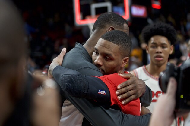 Portland Trail Blazers guard Damian Lillard, right, and Los Angeles Lakers forward LeBron James embrace after an NBA basketball game in Portland, Ore., Friday, Dec. 6, 2019. (AP Photo/Craig Mitchelldyer)
