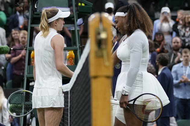 Serena Williams of the US is greeted by Aliaksandra Sasnovich of Belarus, left, at the net after retiring from the women's singles first round match against on day two of the Wimbledon Tennis Championships in London, Tuesday June 29, 2021. (AP Photo/Kirsty Wigglesworth)