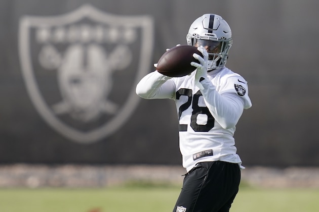Las Vegas Raiders running back Josh Jacobs (28) catches a pass during an NFL football practice Tuesday, June 15, 2021, in Henderson, Nev. (AP Photo/John Locher)