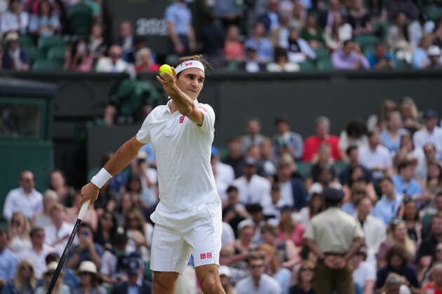 Switzerland's Roger Federer serves to Richard Gasquet of France during the men's singles second round match on day four of the Wimbledon Tennis Championships in London, Thursday July 1, 2021. (AP Photo/Alberto Pezzali)