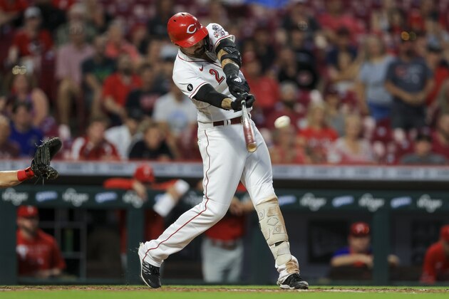 Cincinnati Reds' Nick Castellanos hits a grand slam during the seventh inning of a baseball game against the Philadelphia Phillies in Cincinnati, Monday, June 28, 2021. (AP Photo/Aaron Doster)