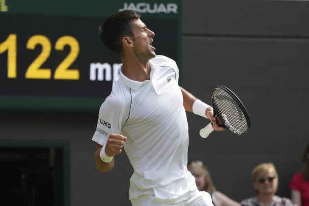 Serbia's Novak Djokovic celebrates winning a point against Denis Kudla of the US during the men's singles third round match on day five of the Wimbledon Tennis Championships in London, Friday July 2, 2021. (AP Photo/Alberto Pezzali)