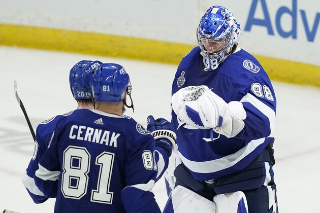 Tampa Bay Lightning goaltender Andrei Vasilevskiy (88) is greeted by defenseman Erik Cernak (81) and center Blake Coleman (20) after the team defeated the Montreal Canadiens, 3-1, in Game 2 of the NHL hockey Stanley Cup finals, Wednesday, June 30, 2021, in Tampa, Fla. (AP Photo/Gerry Broome)