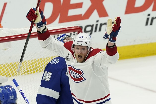 Montreal Canadiens right wing Corey Perry (94) reacts after a goal by Canadiens center Nick Suzuki on Tampa Bay Lightning goaltender Andrei Vasilevskiy (88) during the second period in Game 2 of the NHL hockey Stanley Cup finals, Wednesday, June 30, 2021, in Tampa, Fla. (AP Photo/Gerry Broome)