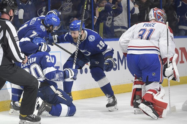 Tampa Bay Lightning center Anthony Cirelli (71) and right wing Barclay Goodrow (19) celebrate with center Blake Coleman (20) after his goal on Montreal Canadiens goaltender Carey Price (31) during the second period in Game 2 of the NHL hockey Stanley Cup finals, Wednesday, June 30, 2021, in Tampa, Fla. (AP Photo/Phelan Ebenhack)