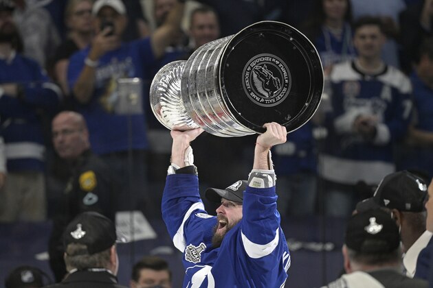 Tampa Bay Lightning right wing Nikita Kucherov hoists the Stanley Cup after the team defeated the Montreal Canadiens in Game 5 of the NHL hockey Stanley Cup finals, Wednesday, July 7, 2021, in Tampa, Fla. (AP Photo/Phelan Ebenhack)