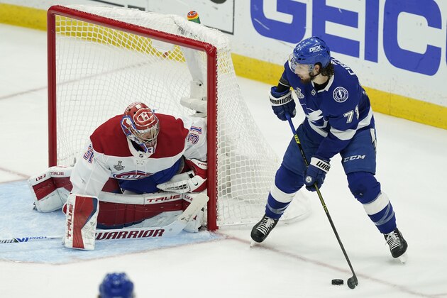 Tampa Bay Lightning center Anthony Cirelli (71) looks to shoot past Montreal Canadiens goaltender Carey Price (31) during the first period in Game 5 of the NHL hockey Stanley Cup finals, Wednesday, July 7, 2021, in Tampa, Fla. (AP Photo/Gerry Broome)