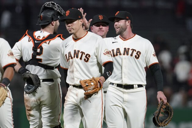 San Francisco Giants' Curt Casali, from left, celebrates with Wilmer Flores, Jake McGee and Darin Ruf after the Giants defeated the St. Louis Cardinals in a baseball game in San Francisco, Wednesday, July 7, 2021. (AP Photo/Jeff Chiu)