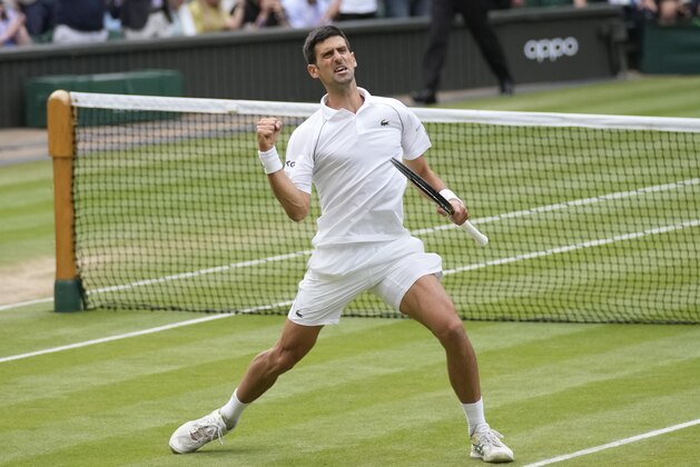 Serbia's Novak Djokovic celebrates after defeating Canada's Denis Shapovalov during the men's singles semifinals match on day eleven of the Wimbledon Tennis Championships in London, Friday, July 9, 2021. (AP Photo/Kirsty Wigglesworth)