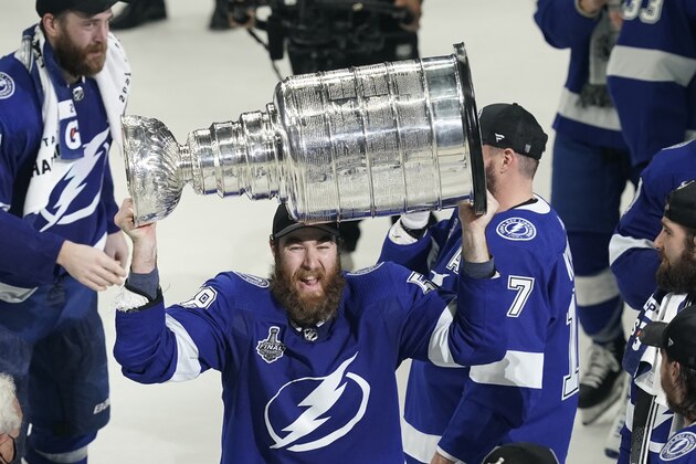 Tampa Bay Lightning defenseman David Savard hoists the Stanley Cup after the series win in Game 5 of the NHL hockey Stanley Cup finals against the Montreal Canadiens, Wednesday, July 7, 2021, in Tampa, Fla. (AP Photo/Gerry Broome)
