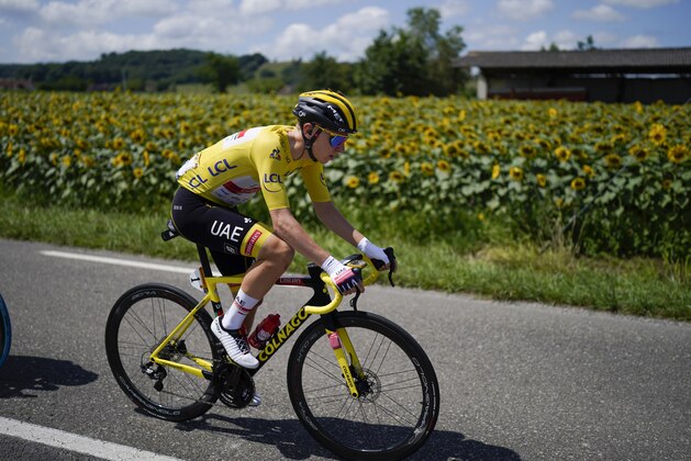 Slovenia's Tadej Pogacar, wearing the overall leader's yellow jersey, rides in the pack during the nineteenth stage of the Tour de France cycling race over 207 kilometers (128.6 miles) with start in Mourenx and finish in Libourne, France,Friday, July 16, 2021. (AP Photo/Daniel Cole)