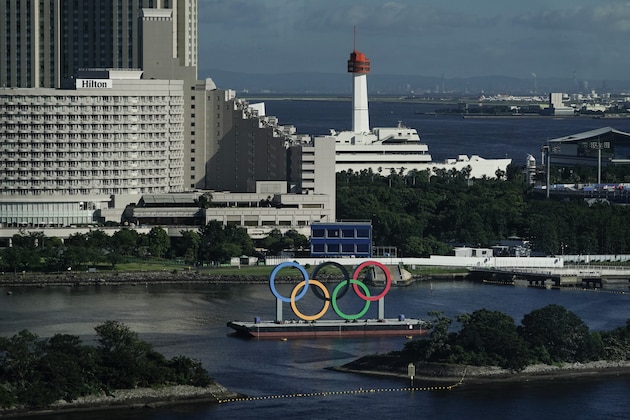 A barge with the Olympic rings mounted on it floats in the water ahead of the 2020 Summer Olympics, Saturday, July 17, 2021, in Tokyo. The pandemic-delayed games open on July 23. (AP Photo/Jae C. Hong)