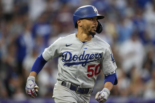 Los Angeles Dodgers' Mookie Betts watches his double off Colorado Rockies relief pitcher Mychal Givens during the seventh inning of a baseball game Saturday, July 17, 2021, in Denver. (AP Photo/David Zalubowski)
