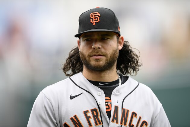 San Francisco Giants shortstop Brandon Crawford (35) walks to the dugout before the first baseball game of a doubleheader, Saturday, June 12, 2021, in Washington. This game is a makeup of a postponed game from Thursday. (AP Photo/Nick Wass)