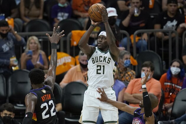 Milwaukee Bucks guard Jrue Holiday (21) shoots against the Phoenix Suns during the second half of Game 5 of basketball's NBA Finals, Saturday, July 17, 2021, in Phoenix. (AP Photo/Ross D. Franklin)