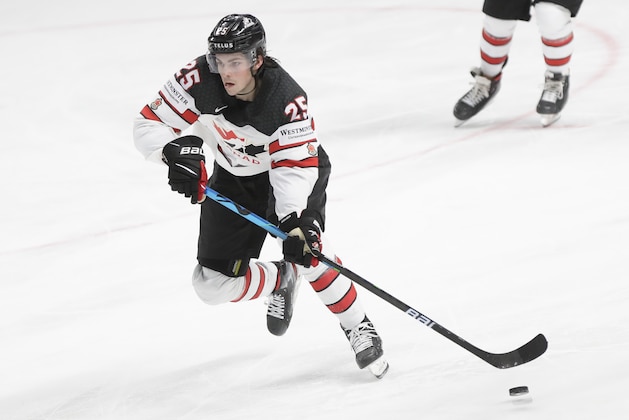 Canada's Owen Power controls the puck during the Ice Hockey World Championship semifinal match between the United States and Canada at the Arena in Riga, Latvia, Saturday, June 5, 2021. (AP Photo/Sergei Grits)