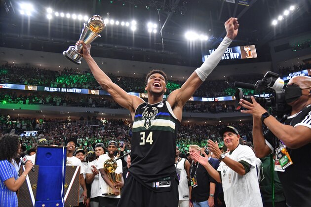 MILWAUKEE, WI - JULY 20: Giannis Antetokounmpo #34 of the Milwaukee Bucks celebrates after receiving the Bill Russell Finals MVP Award after winning Game Six of the 2021 NBA Finals against the Phoenix Suns on July 20, 2021 at Fiserv Forum in Milwaukee, Wisconsin. NOTE TO USER: User expressly acknowledges and agrees that, by downloading and/or using this Photograph, user is consenting to the terms and conditions of the Getty Images License Agreement. Mandatory Copyright Notice: Copyright 2021 NBAE (Photo by Jesse D. Garrabrant/NBAE via Getty Images)