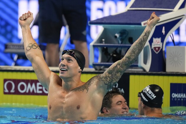 Caeleb Dressel reacts after winning the men's 50 freestyle during wave 2 of the U.S. Olympic Swim Trials on Sunday, June 20, 2021, in Omaha, Neb. (AP Photo/Charlie Neibergall)