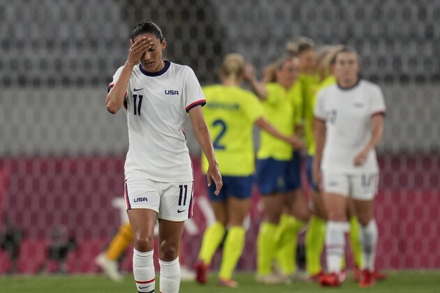 United States' Christen Press reacts as Sweden's players celebrate their third goal during a women's soccer match at the 2020 Summer Olympics, Wednesday, July 21, 2021, in Tokyo. (AP Photo/Ricardo Mazalan)