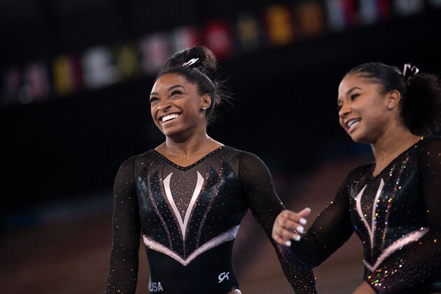 US gymnast Simone Biles jokes with her teammate Jordan Chiles while taking part in a training session at the Ariake Gymnastics Centre in Tokyo on July 22, 2021, on the eve of the start of the Tokyo 2020 Olympic Games. (Photo by Loic VENANCE / AFP) (Photo by LOIC VENANCE/AFP via Getty Images)