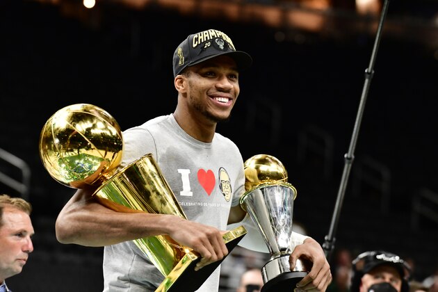 MILWAUKEE, WI - JULY 20: Giannis Antetokounmpo #34 of the Milwaukee Bucks holds the Bill Russell NBA Finals MVP Award and Larry O'Brien Trophy after defeating the Phoenix Suns in Game Six to win the 2021 NBA Finals during Game Six of the 2021 NBA Finals on July 20, 2021 at the Fiserv Forum Center in Milwaukee, Wisconsin. NOTE TO USER: User expressly acknowledges and agrees that, by downloading and or using this Photograph, user is consenting to the terms and conditions of the Getty Images License Agreement. Mandatory Copyright Notice: Copyright 2021 NBAE (Photo by Barry Gossage/NBAE via Getty Images).