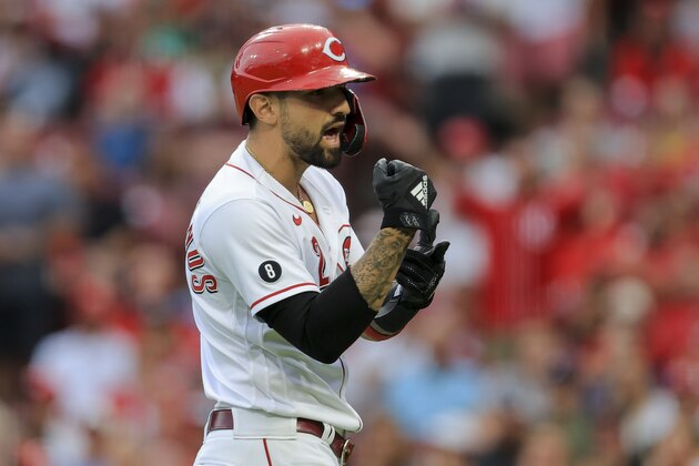 Cincinnati Reds' Nick Castellanos points to his wrist as he yells towards the dugout of the Milwaukee Brewers during a baseball game against in Cincinnati, Friday, July 16, 2021. Castellanos was hit by a pitch during his at bat. The Brewers won 11-6. (AP Photo/Aaron Doster)