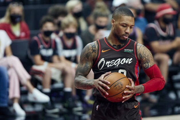 Portland Trail Blazers guard Damian Lillard holds the ball during the first half of Game 6 of an NBA basketball first-round playoff series Thursday, June 3, 2021, in Portland, Ore. (AP Photo/Craig Mitchelldyer)
