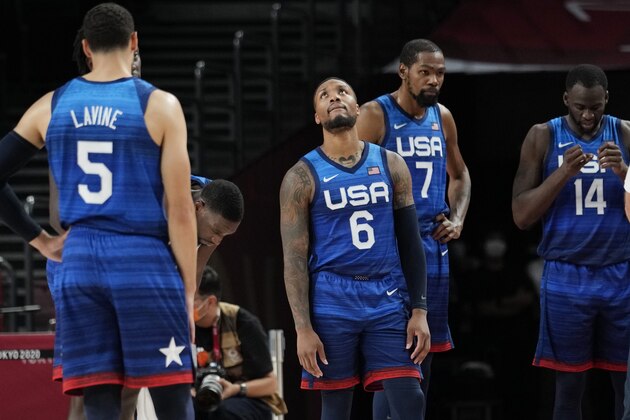 United States' Damian Lillard (6), Kevin Durant (7), and Draymond Green (16) their loss to France in wait for play to resume during their loss to France in a men's basketball preliminary round game at the 2020 Summer Olympics, Sunday, July 25, 2021, in Saitama, Japan. (AP Photo/Eric Gay)