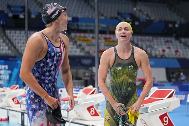 Ariarne Titmus of Australia, right, leaves the pool after winning the final of the women's 400-meters freestyle as Katie Ledecky of the United States watches at the 2020 Summer Olympics, Monday, July 26, 2021, in Tokyo, Japan. (AP Photo/Martin Meissner)