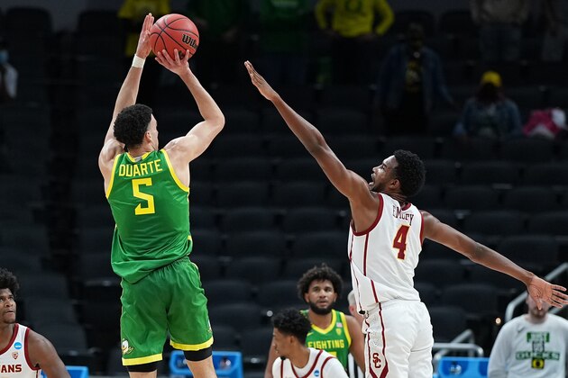 INDIANAPOLIS, IN - MARCH 28: Chris Duarte #5 of the Oregon Ducks shoots against Evan Mobley #4 of the USC Trojans in the Sweet Sixteen round of the 2021 NCAA Division I Men's Basketball Tournament held at Bankers Life Fieldhouse on March 28, 2021 in Indianapolis, Indiana. (Photo by Jack Dempsey/NCAA Photos via Getty Images)
