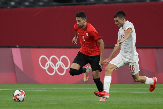 Egypt's midfielder Taher Mohamed (L) competes for the ball with Spain's midfielder Pedri Gonzalez (R) during the Tokyo 2020 Olympic Games men's group C first round football match between Egypt and Spain at Sapporo Dome in Sapporo on July 22, 2021. (Photo by ASANO IKKO / AFP) (Photo by ASANO IKKO/AFP via Getty Images)