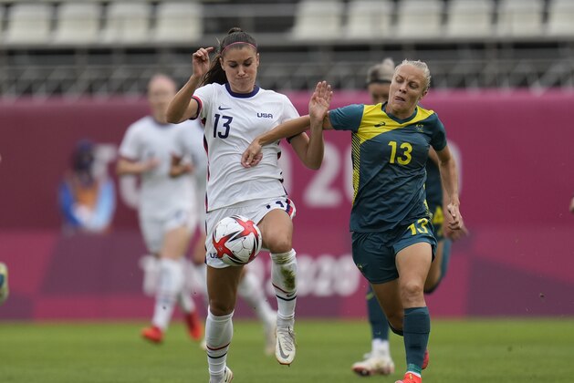 United States' Alex Morgan, left, and Australia's Tameka Yallop battle for the ball during a women's soccer match at the 2020 Summer Olympics, Tuesday, July 27, 2021, in Kashima, Japan. (AP Photo/Fernando Vergara)