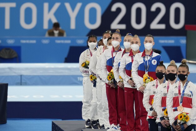 From left, United States' gymnasts Jordan Chiles, Simone Biles, Grace Mc Callum, Sunisa Lee and Russian Olympic Committee's gymnasts Liliia Akhaimova, Viktoriia Listunova, Angelina Melnikova and Vladislava Urazova and Britain's artistic gymnastics women's team, Jennifer Gadirova, Jessica Gadirova, Alice Kinsella and Amelie Morgan stand during the medal ceremony for the artistic women's team at the 2020 Summer Olympics, Tuesday, July 27, 2021, in Tokyo. (AP Photo/Gregory Bull)