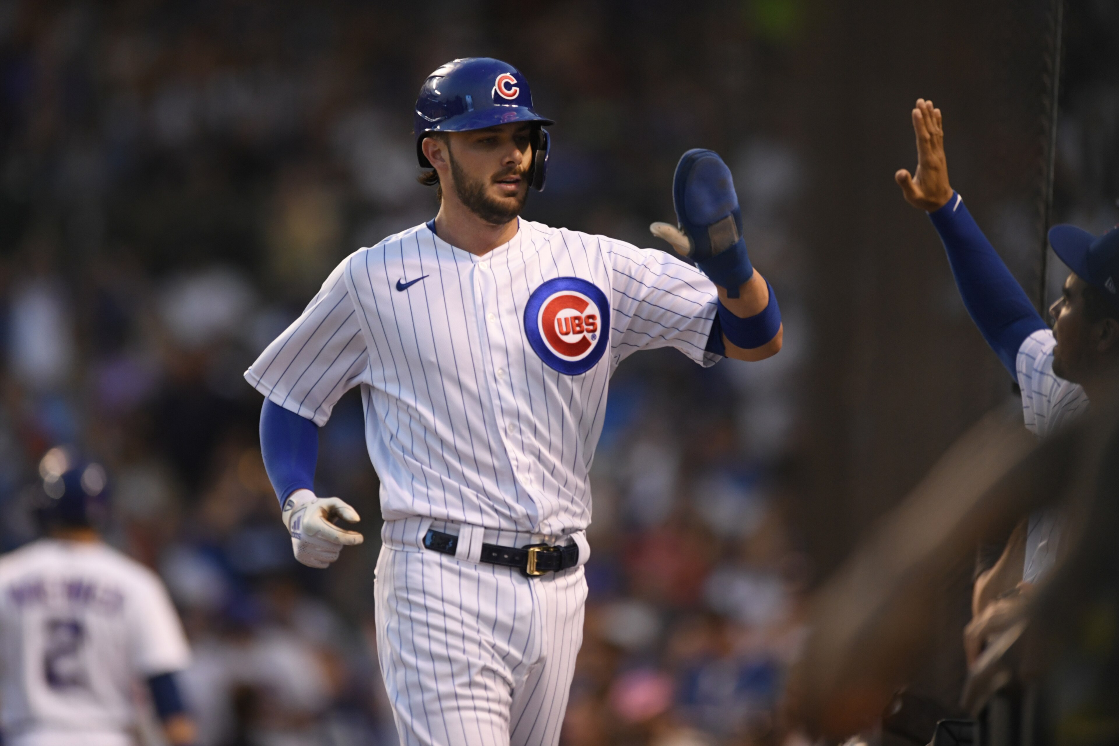 Chicago Cubs' Kris Bryant, front left, celebrates at the dugout after scoring on a David Bote single during the third inning of a baseball game against the Cincinnati Reds, Monday, July 26, 2021, in Chicago. (AP Photo/Paul Beaty) Chicago Cubs' Kris Bryant, front left, celebrates at the dugout after scoring on a David Bote single during the third inning of a baseball game against the Cincinnati Reds, Monday, July 26, 2021, in Chicago. (AP Photo/Paul Beaty)