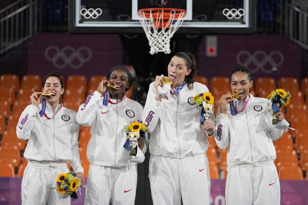 Members of team United States, from left to right, Kelsey Plum, Jacquelyn Young, Stefanie Dolson and Allisha Gray pose with their gold medals during the awards ceremony for women's 3-on-3 basketball at the 2020 Summer Olympics, Wednesday, July 28, 2021, in Tokyo, Japan. (AP Photo/Jeff Roberson)