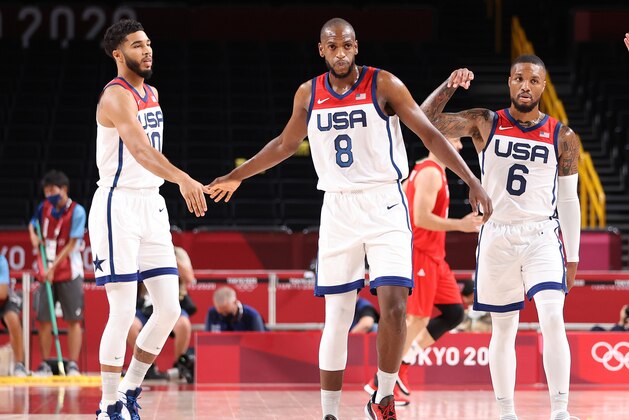 SAITAMA, JAPAN - JULY 28: Khris Middleton #8 of Team United States high fves teammate Jayson Tatum #10 and Damian Lillard #6 during the first half of a Men's Preliminary Round Group A game on day five of the Tokyo 2020 Olympic Games at Saitama Super Arena on July 28, 2021 in Saitama, Japan. (Photo by Gregory Shamus/Getty Images)