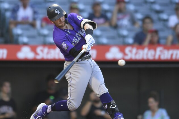 Colorado Rockies shortstop Trevor Story hits a home run in the first inning of a baseball game against the Los Angeles Angels on Wednesday, July 28, 2021, in Anaheim, Calif. (AP Photo/John McCoy)
