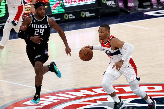 WASHINGTON, DC - MARCH 17: Russell Westbrook #4 of the Washington Wizards dribbles the ball against Buddy Hield #24 of the Sacramento Kings in the first half at Capital One Arena on March 17, 2021 in Washington, DC. NOTE TO USER: User expressly acknowledges and agrees that, by downloading and or using this photograph, User is consenting to the terms and conditions of the Getty Images License Agreement. (Photo by Rob Carr/Getty Images)